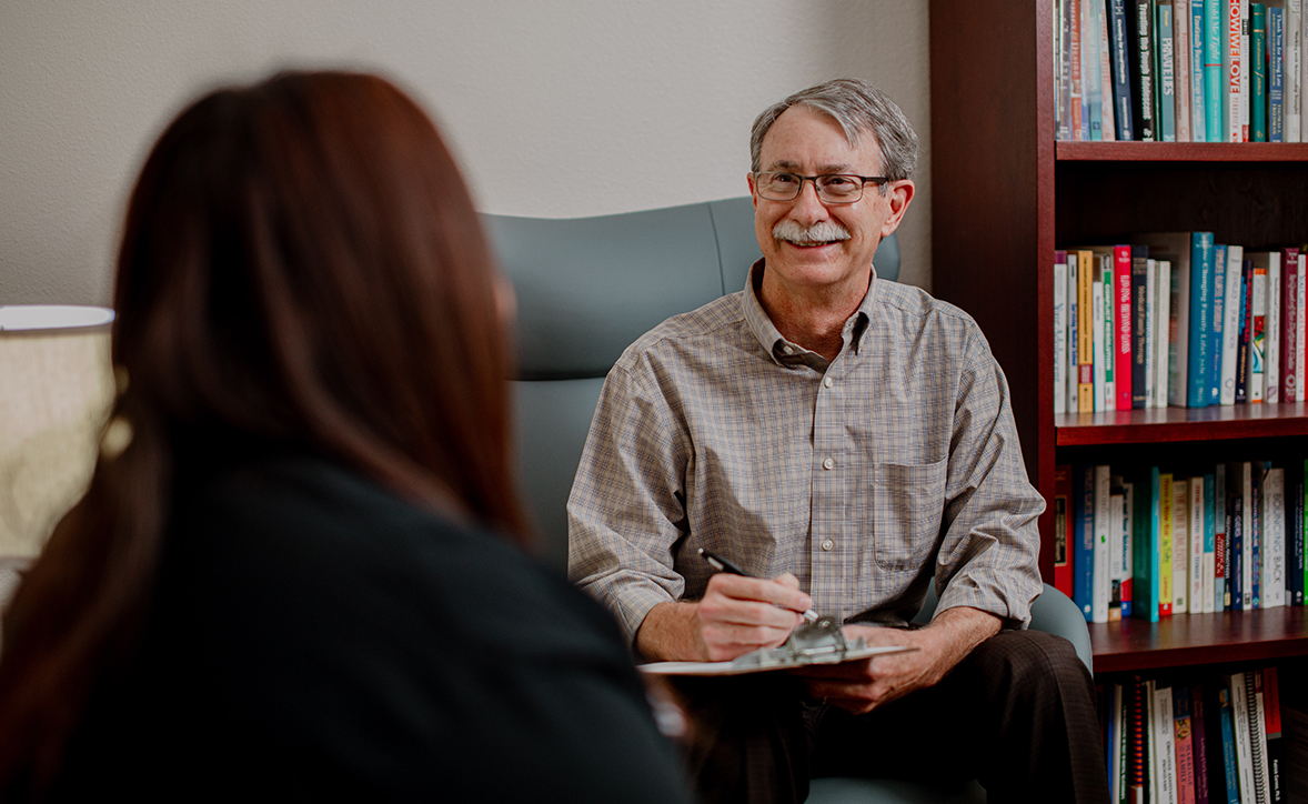 provider sitting with a patient in a counseling room